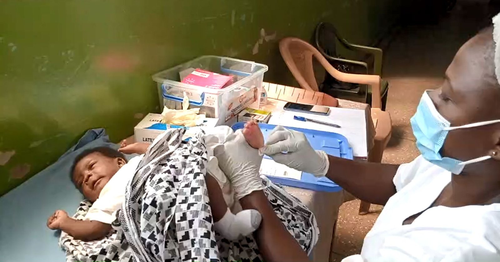 Young African child receiving medical care in a hospital ward for sickle cell complications