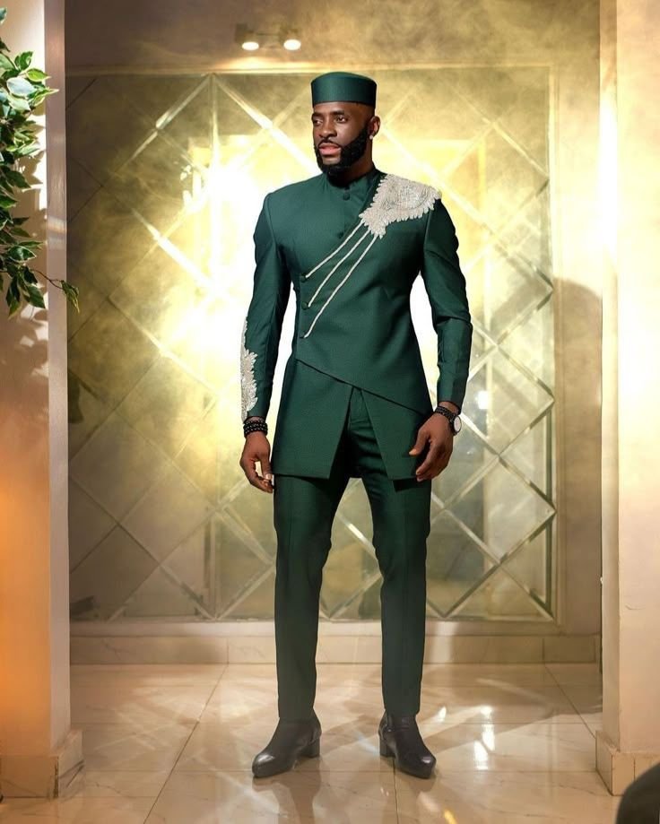 African man wearing structured green modern traditional formal outfit with decorative detailing